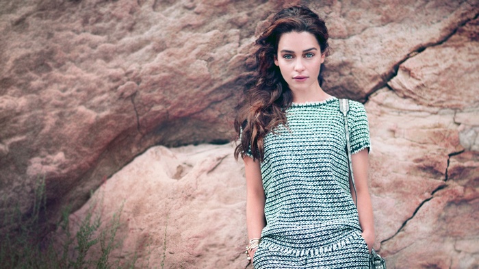 Emilia Clarke posing in front of a rock formation