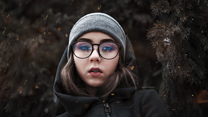 Portrait of a woman with glasses and a hood