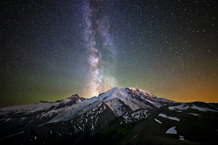 Milky Way over snow-capped mountains at night
