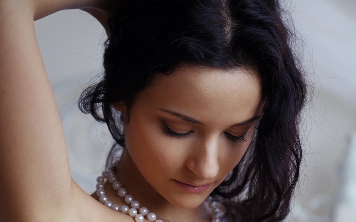 Ardelia A with black hair and pearl necklace