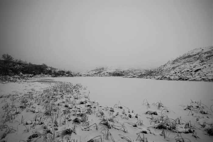 Snowy landscape in Norway with mist over mountains