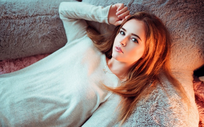 Polina Grenc wearing a white sweater with a necklace
