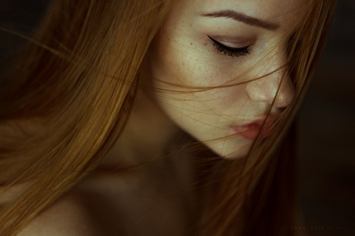Portrait of Anastasia Lis with red hair and freckles