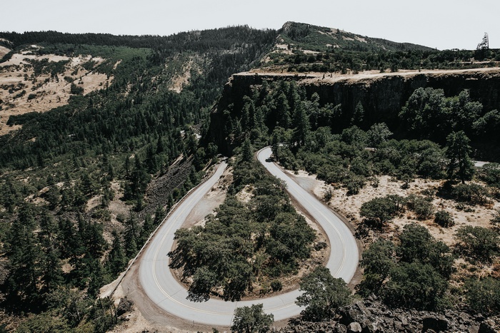 Winding mountain road through a forested landscape