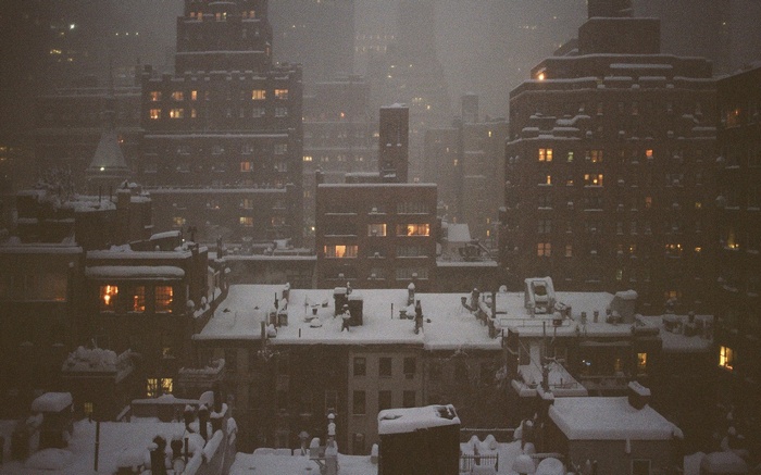 Cityscape at night during a snowstorm