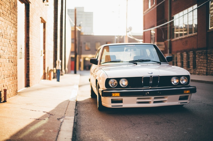 White BMW E28 parked on a street