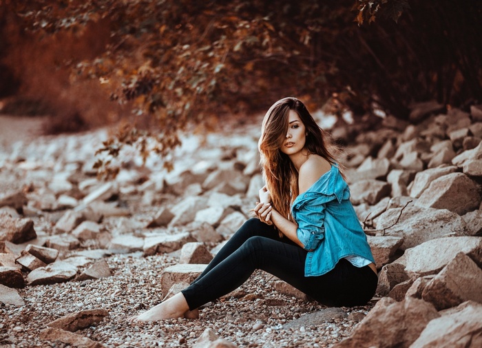 Woman sitting on rocks outdoors
