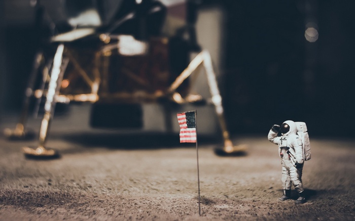 Astronaut salutes American flag near lunar module