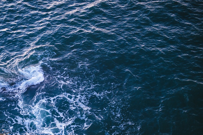Dark blue ocean waves with white foam
