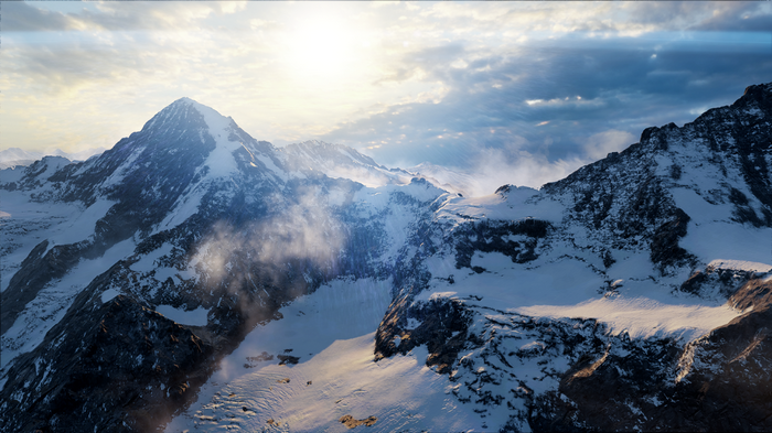 Snowy mountains under a bright sun and cloudy sky