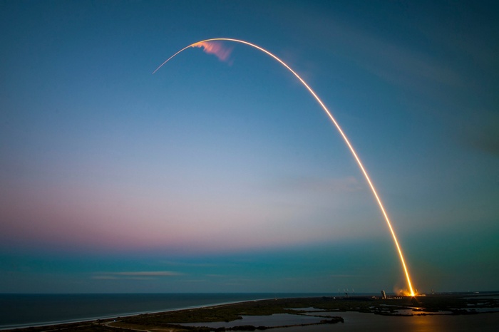 SpaceX Falcon 9 rocket launch at dusk