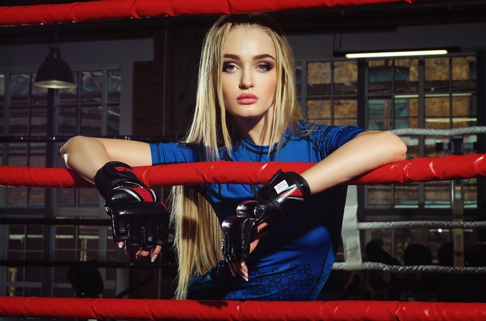 Kristiana Koroleva in a boxing ring wearing gloves