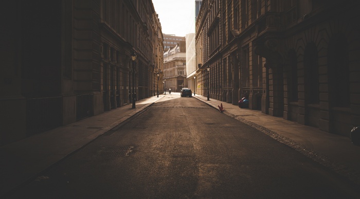 Urban street with buildings and a car