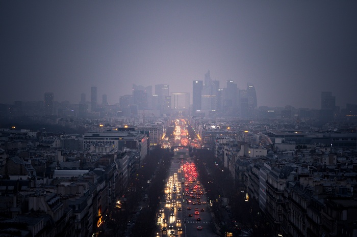 Paris cityscape in mist with traffic on Champs-Élysées