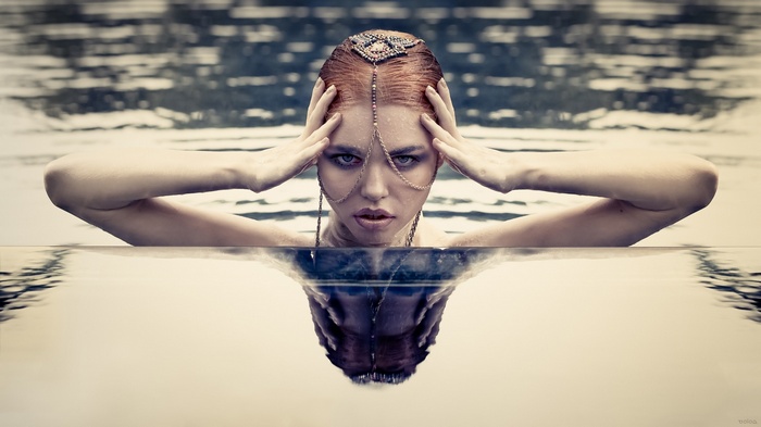 Woman with ornate headpiece in water