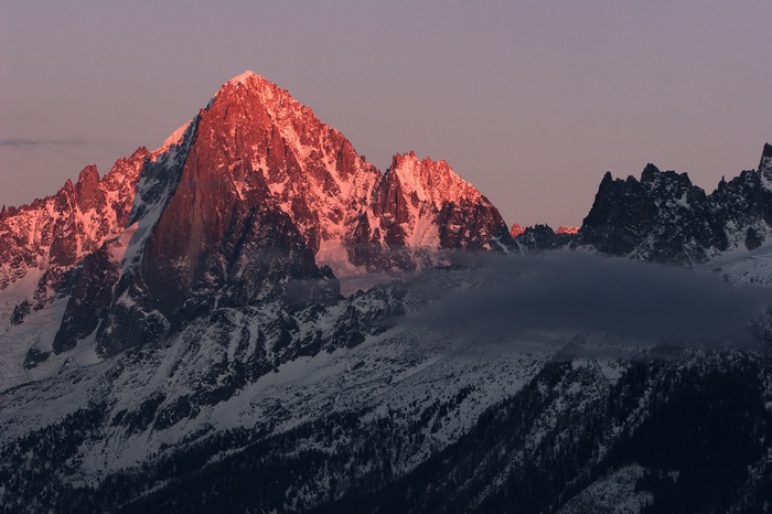 Snow-capped mountains illuminated by sunset