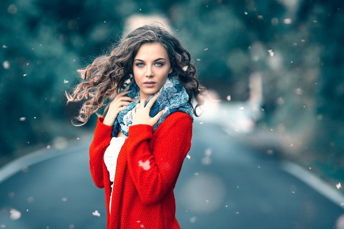 Woman in red sweater with scarf in snow