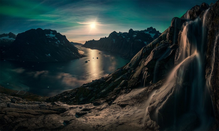 Waterfall and Aurora over Greenland Fjord