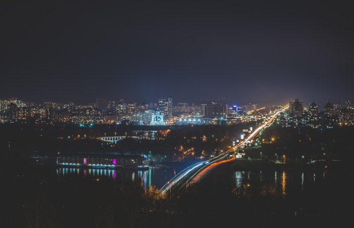 Cityscape at night with illuminated bridge and buildings