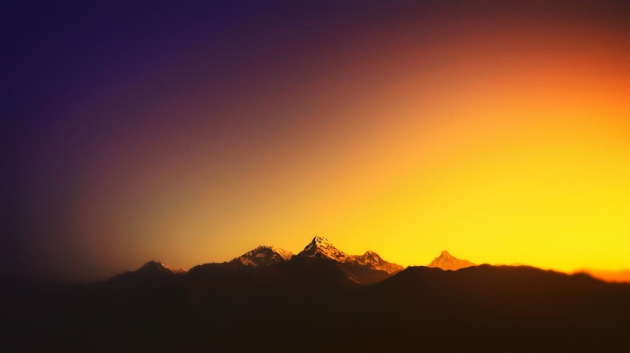 Silhouette of snow-capped mountains at sunset in Nepal