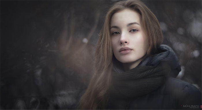 Woman with long brown hair and scarf