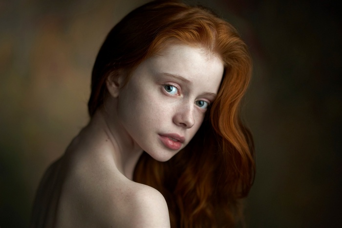 Portrait of a young redhead woman with green eyes