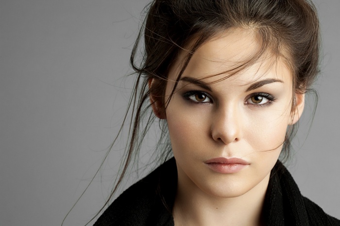 Woman's face with dark eye makeup