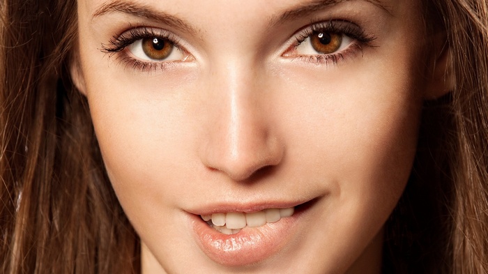 Close-up of a woman with brown eyes and brunette hair