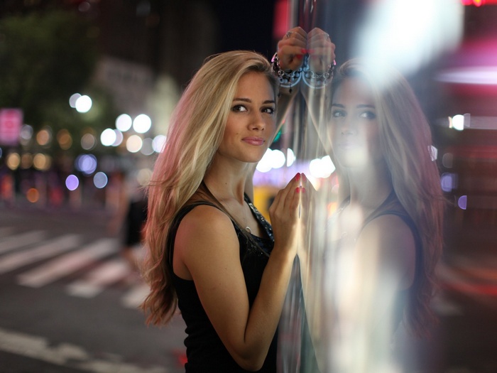 Woman posing in a city at night