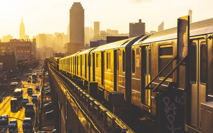 Elevated train in New York City at sunrise