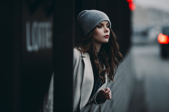 Woman in a gray beanie and white coat