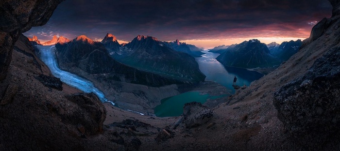 Panorama of Greenland mountains with glacier at sunset