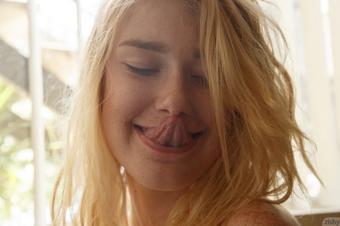 Lyndie Brittain with freckles and tongue out