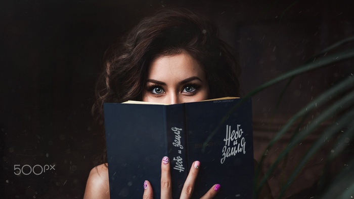 Woman with blue eyes reading a book