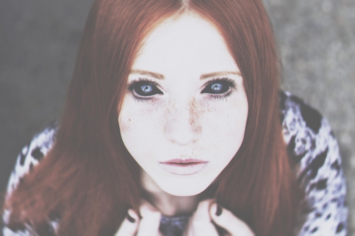 Woman with red hair and black eyes