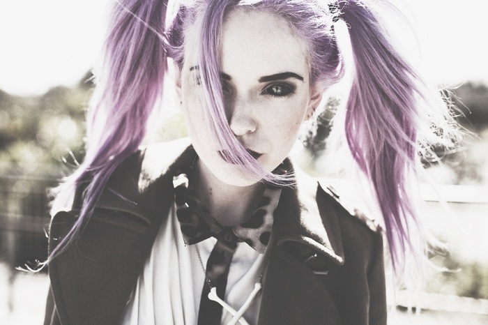 Woman with purple pigtails and dark makeup