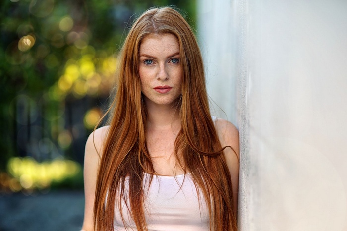 Redhead woman with blue eyes and freckles outdoors
