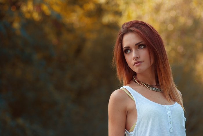 Redhead woman with necklace outdoors