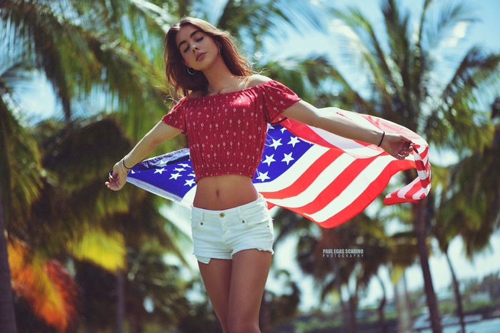 Woman with American flag and palm trees