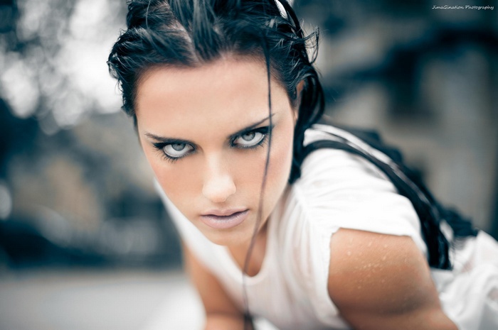 Woman with wet hair and white dress looking at viewer