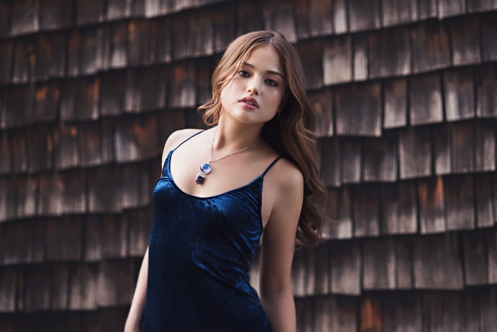 Woman in blue velvet dress with necklace