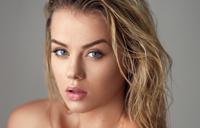 Portrait of a woman with blonde hair and blue eyes