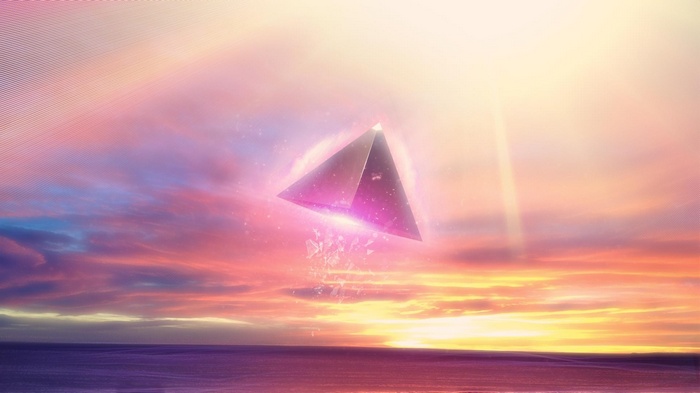 Abstract pyramid floating over the sea at sunset