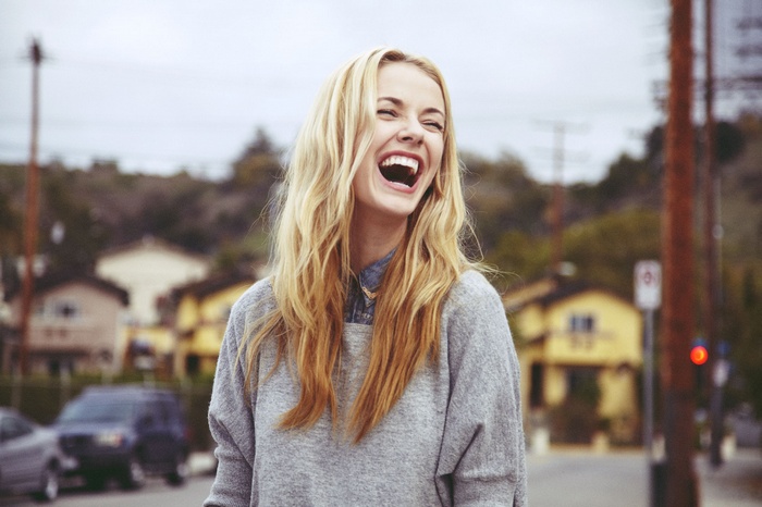 Woman laughing outdoors