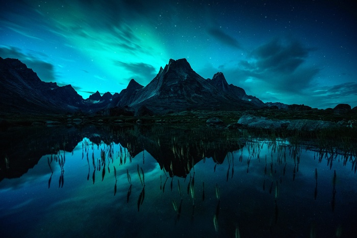 Aurora Borealis over a mountain lake