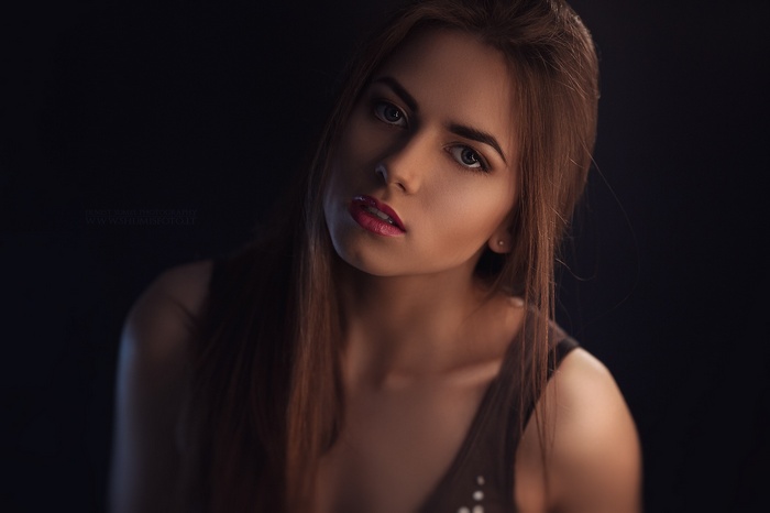 Close-up portrait of a woman with blue eyes and brunette hair
