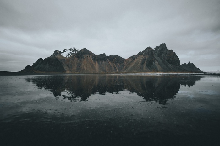 Snow-capped mountains reflected in water