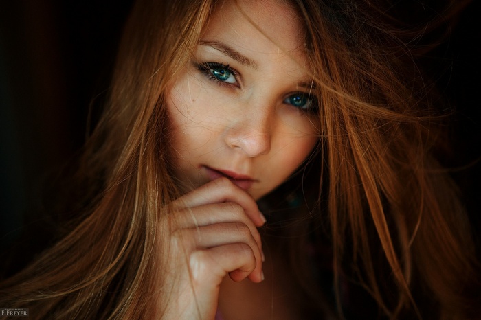 Portrait of a young woman with blue eyes and long hair