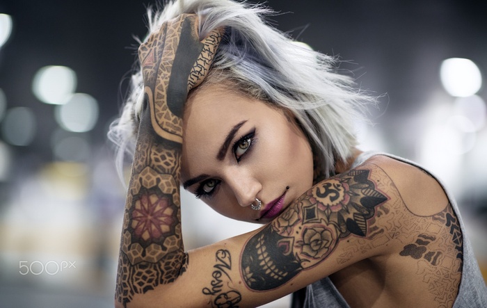 Portrait of a tattooed woman with grey hair