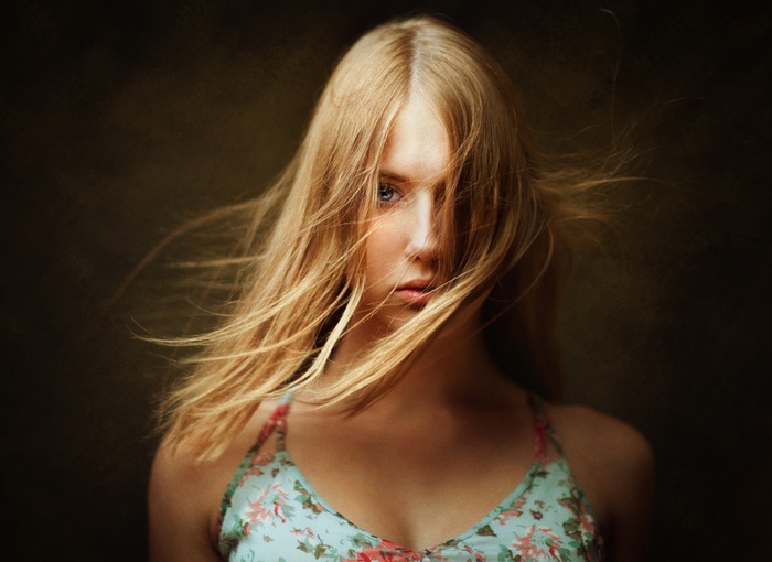 Woman with blonde hair in her face